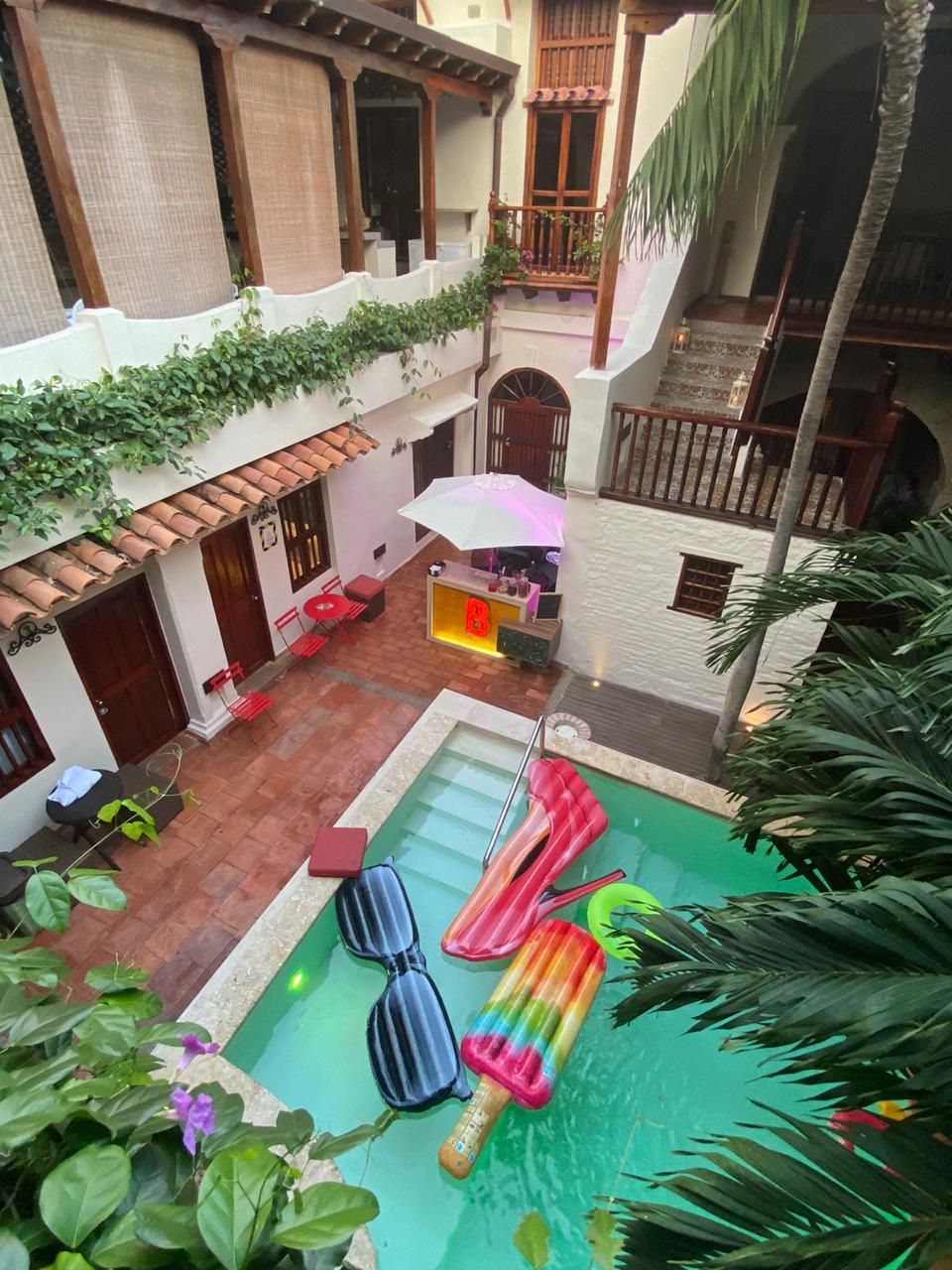 An aerial view of a swimming pool with floats in it