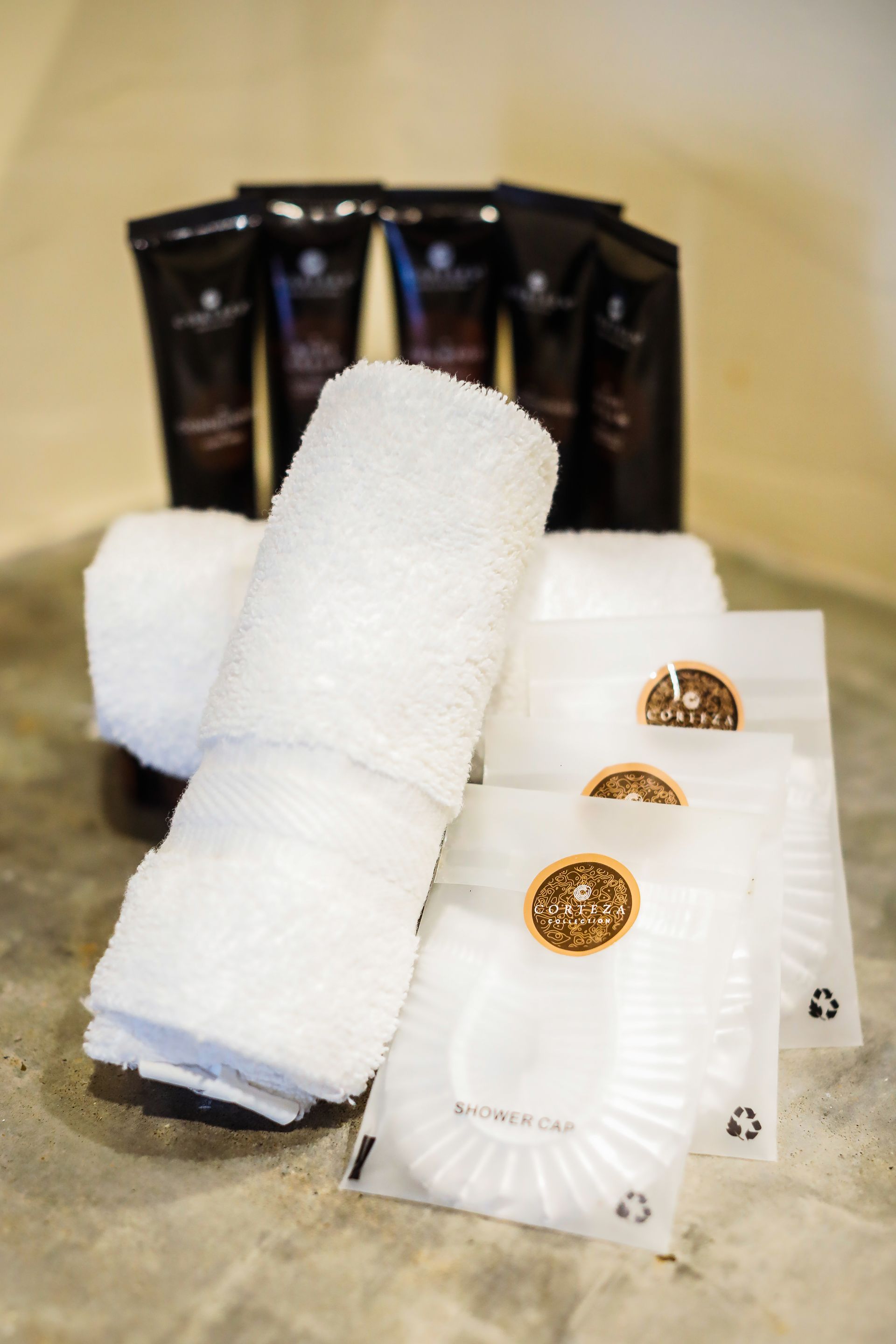 A bunch of towels and soaps are sitting on a table.