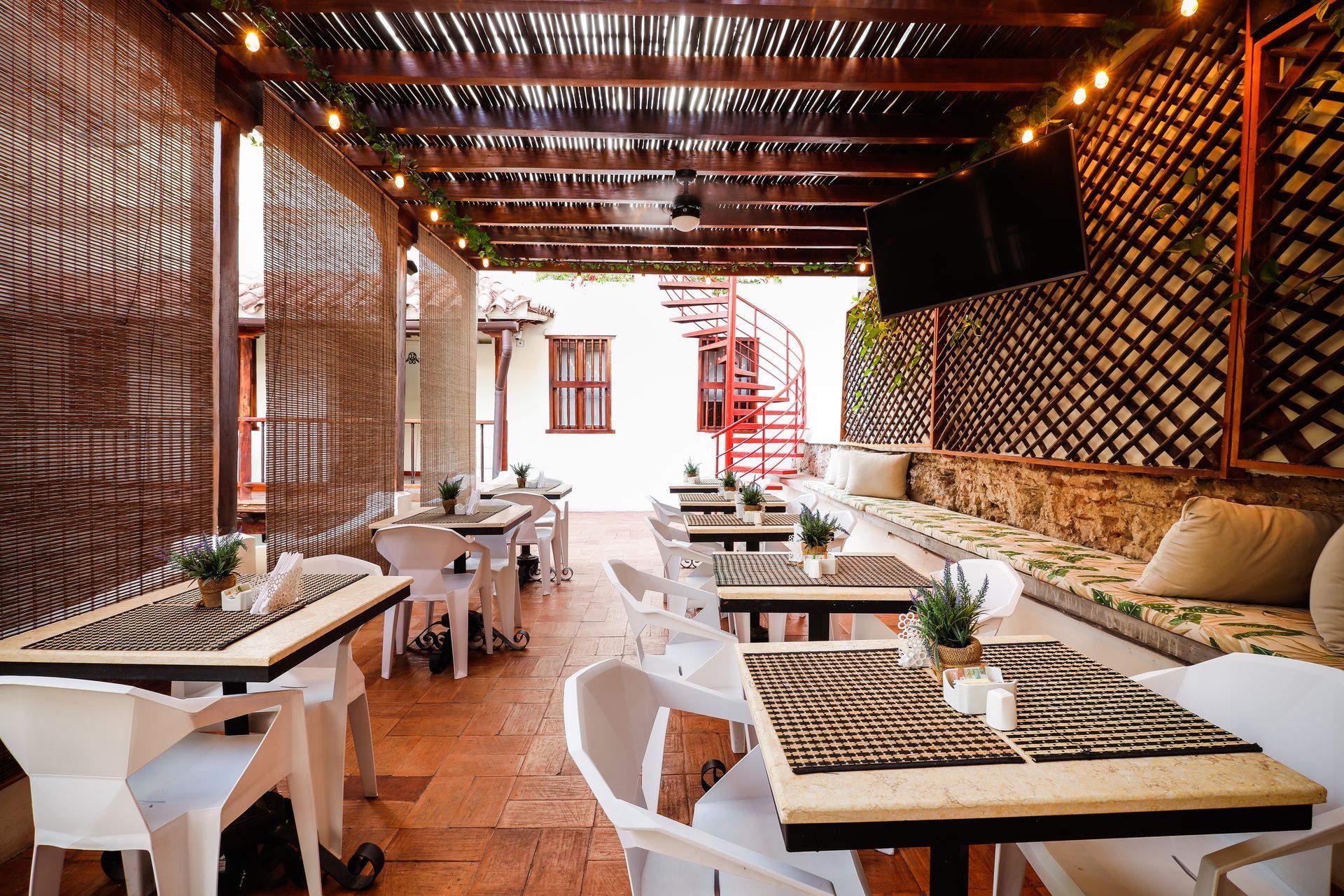 A restaurant with tables and chairs and a fire escape.