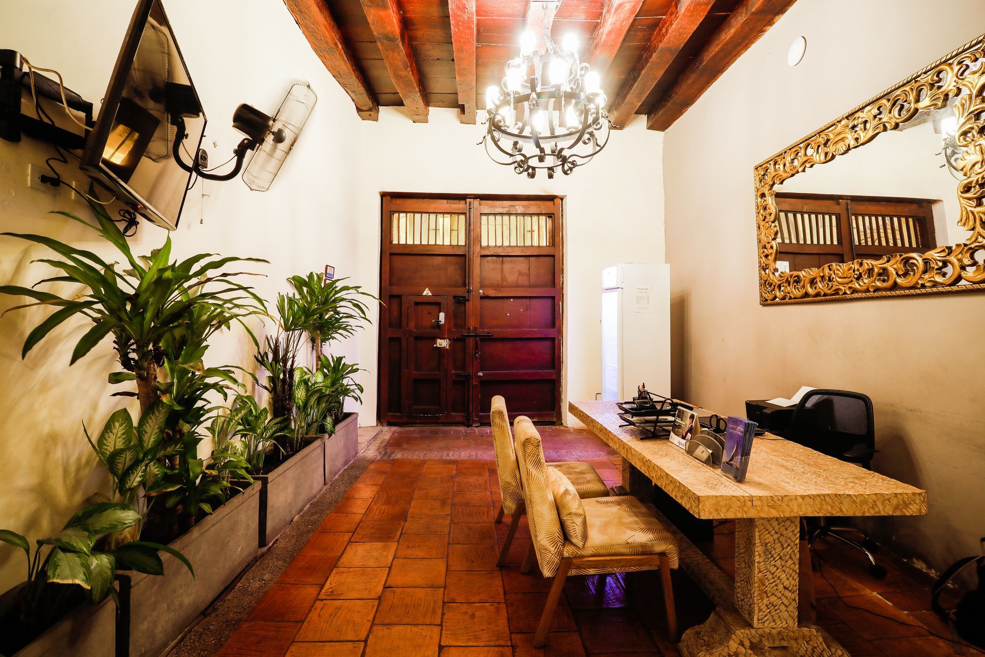 A long hallway with a table and chairs in it