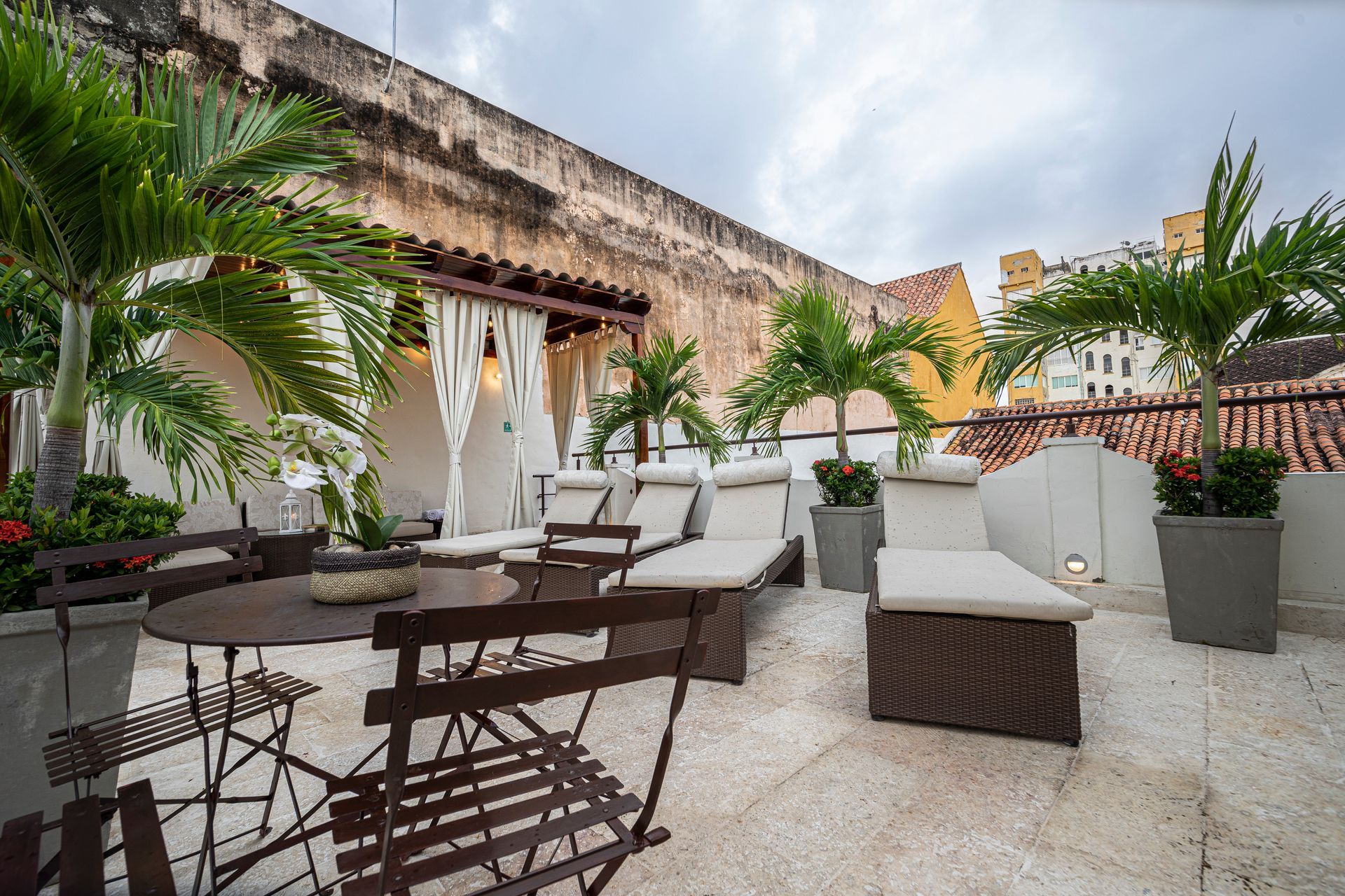 There is a table and chairs on the roof of a building.
