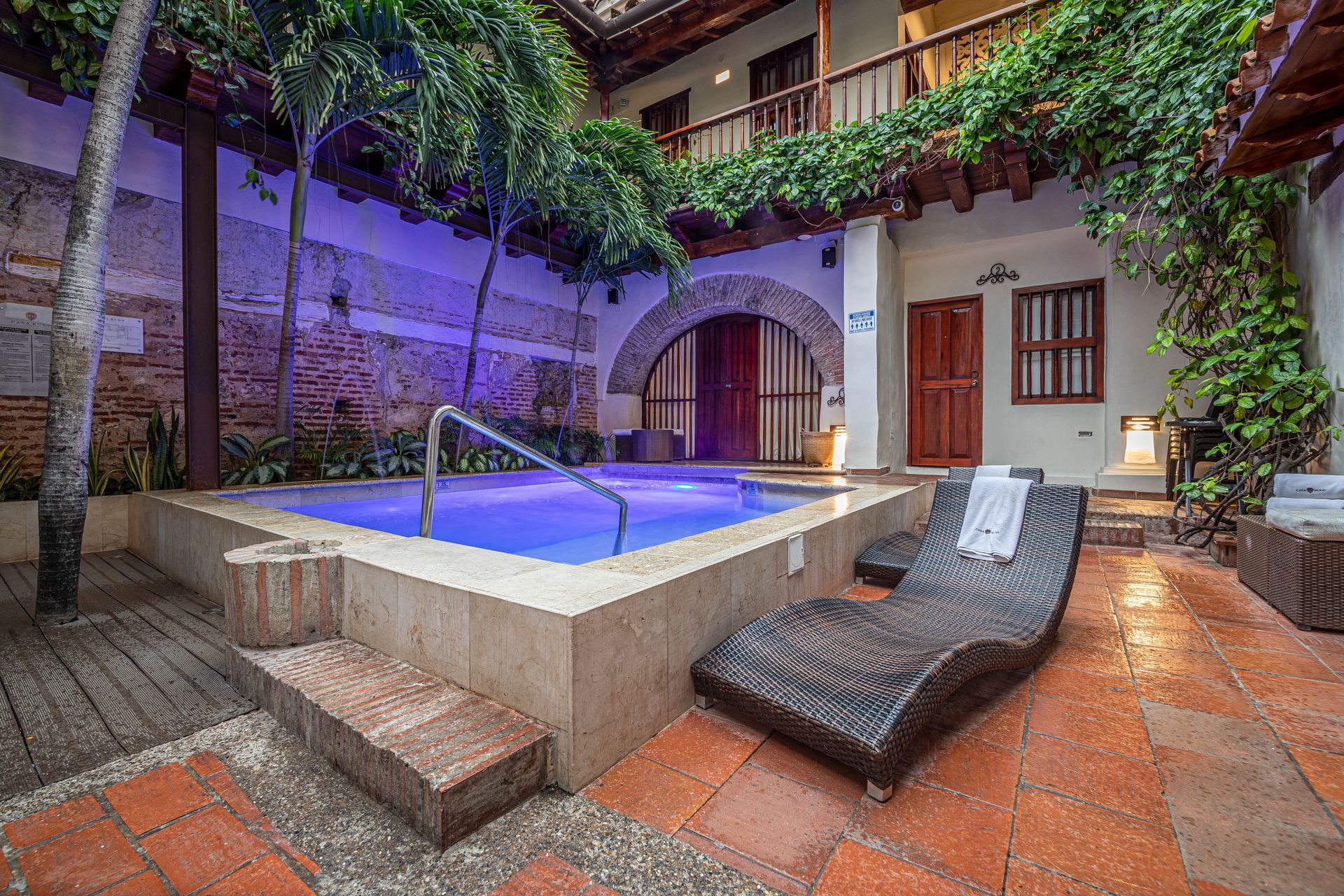 There is a large swimming pool in the middle of the courtyard.