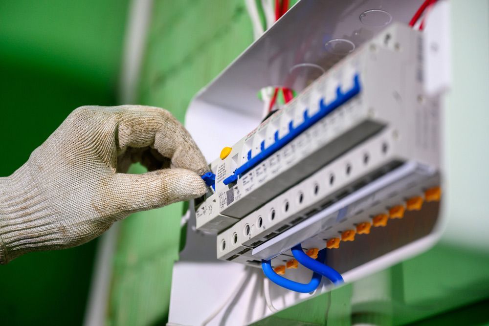 A Person is Working on an Electrical Box — Cairns Synergy Electrical in Manunda, QLD