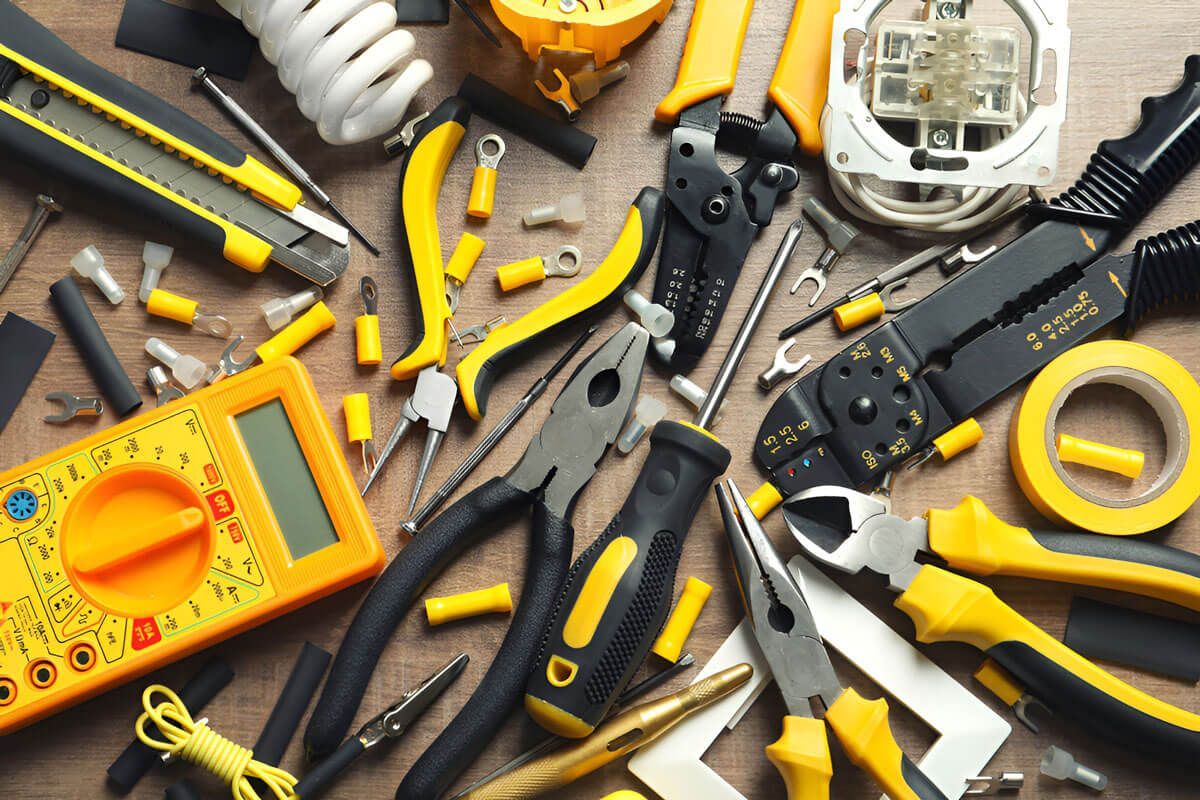 A Bunch of Yellow and Black Tools are on a Wooden Table — Cairns Synergy Electrical in Gordonvale, QLD