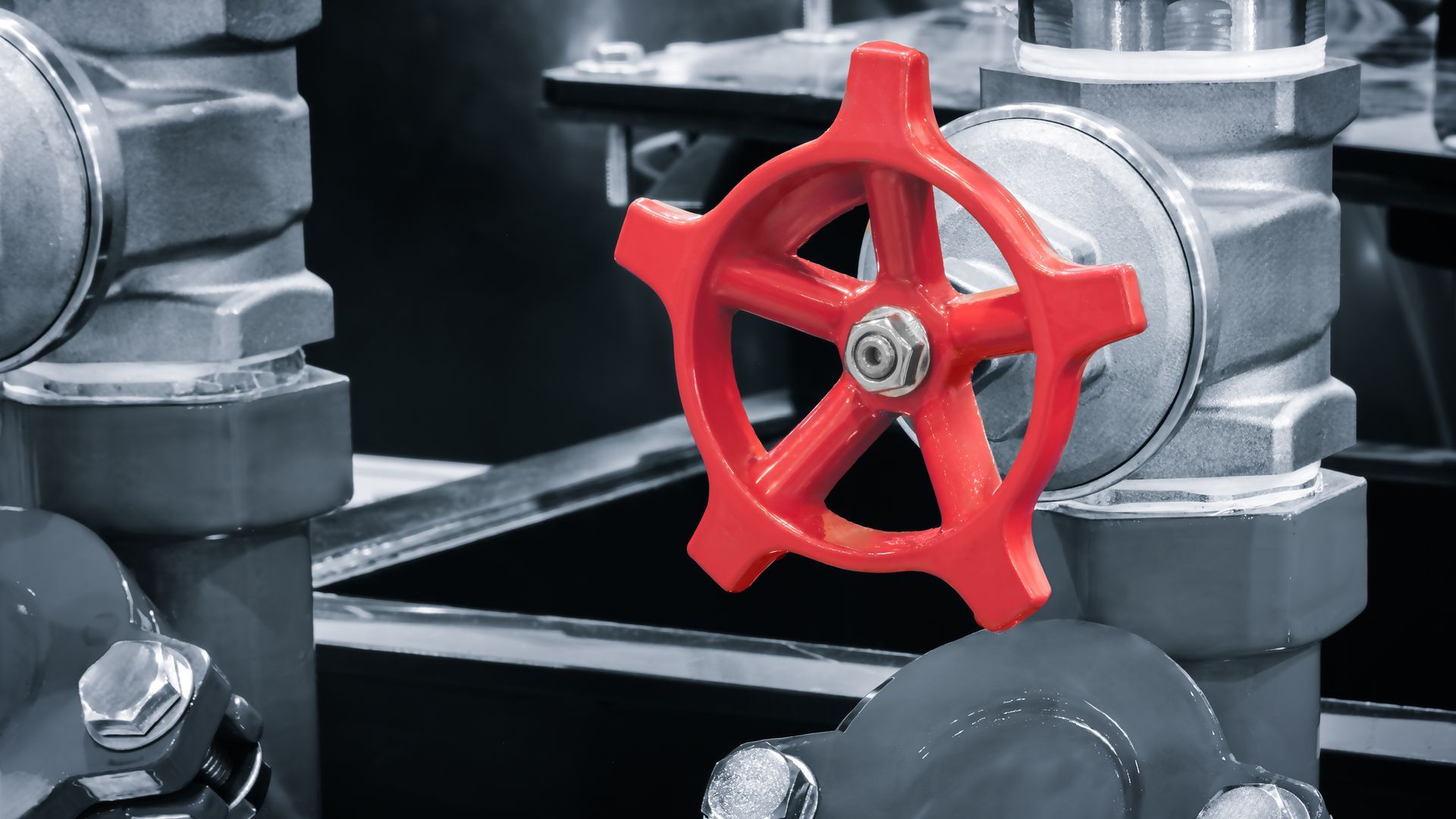 Red valve handle on industrial pipes. Red valve handle on industrial pipes.