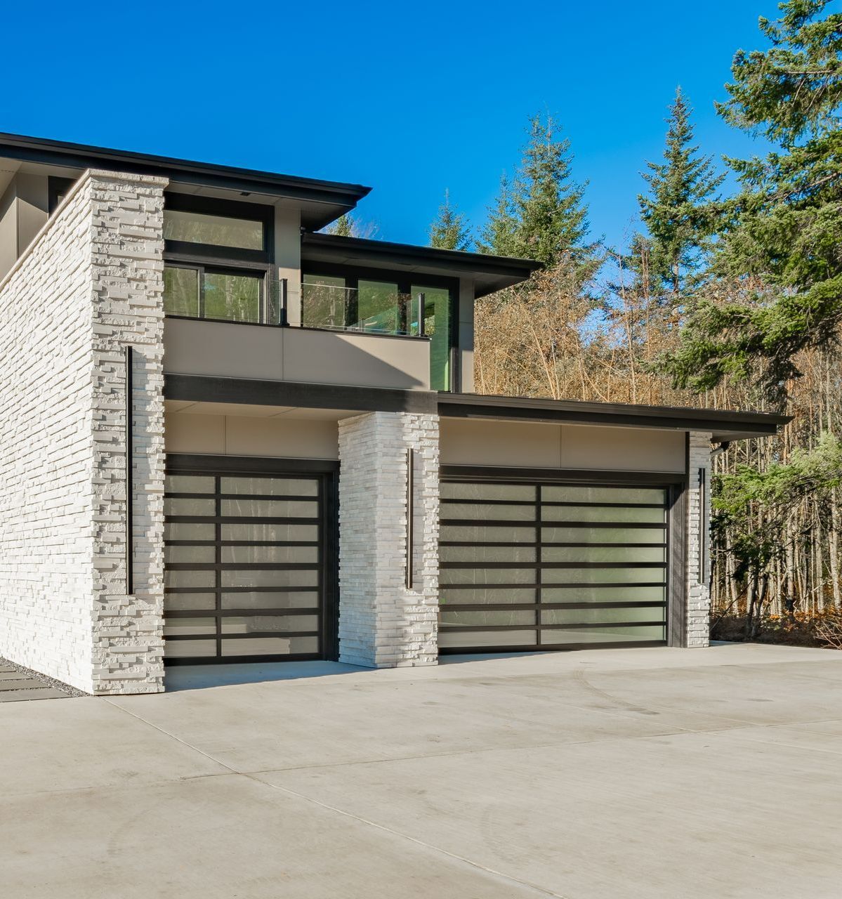 A house with two garage doors and a brick wall