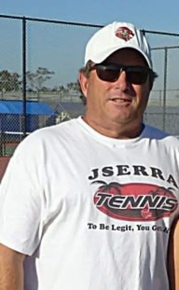 Two men standing next to each other on a tennis court