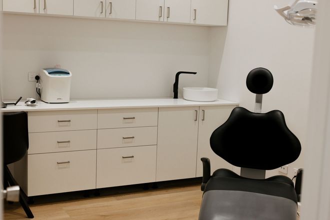 Three Dentures Are Sitting On Top Of Each Other On A Table — Harvey Smiles Denture Clinic In Burleigh Heads, QLD