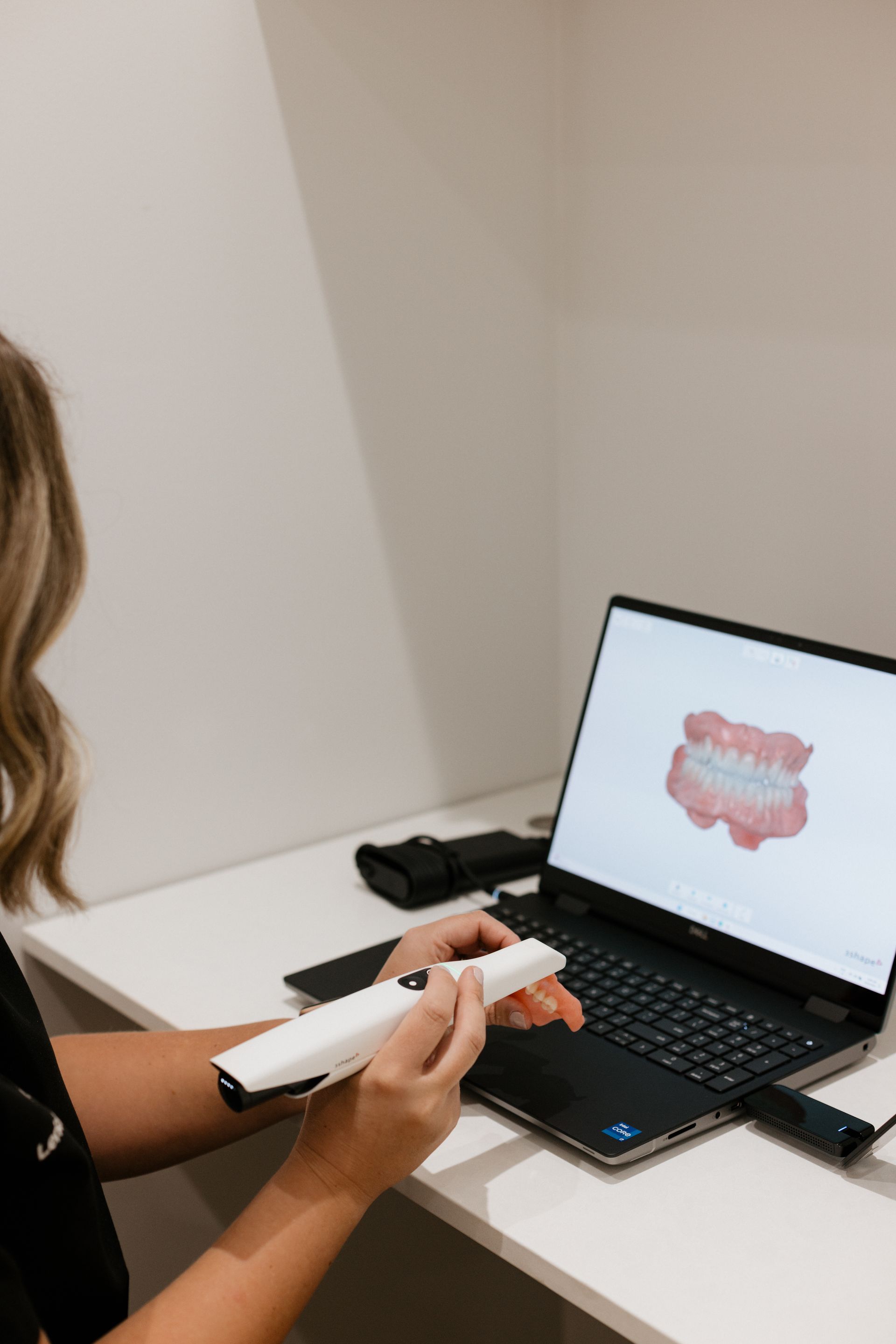 A Woman Is Getting Her Teeth Examined By A Dentist — Harvey Smiles Denture Clinic In Burleigh Heads, QLD