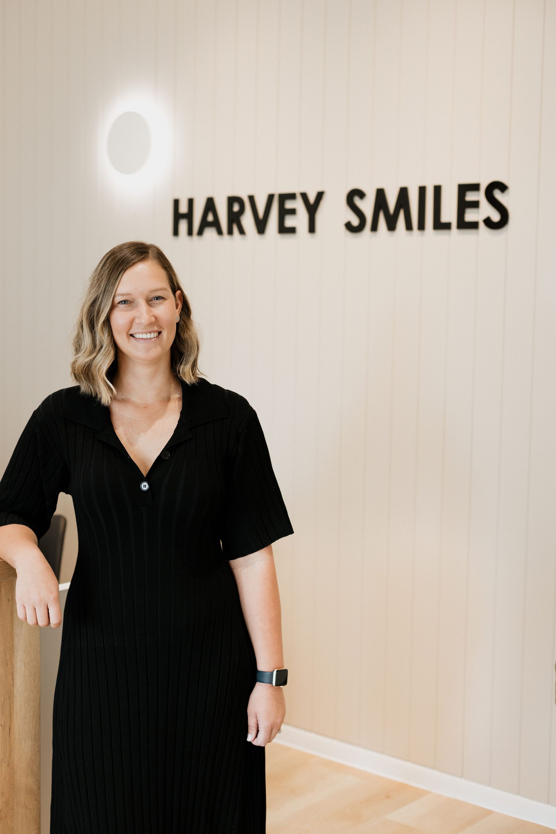 A Woman In A Black Dress — Harvey Smiles Denture Clinic In Burleigh Heads, QLD