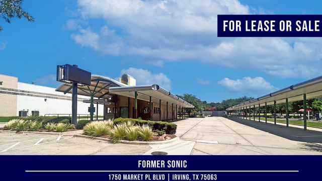 Former Sonic drive-in available for lease or sale. Exterior view of empty building and parking lot under a blue sky.