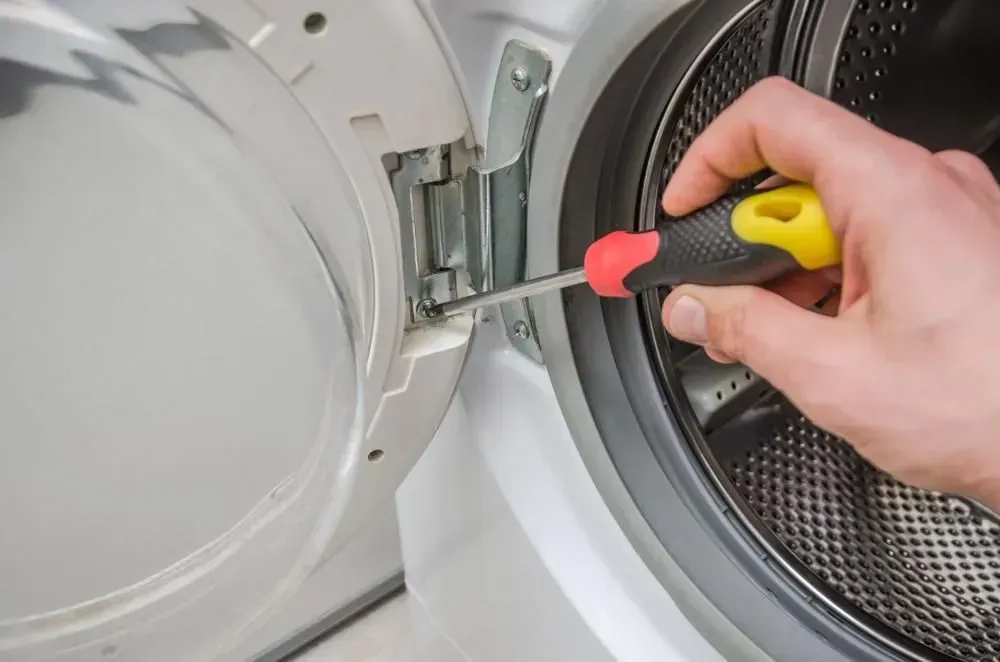Person Uses a Yellow and Black Screwdriver — Eurocoast Appliance Service In Woy Woy, NSW