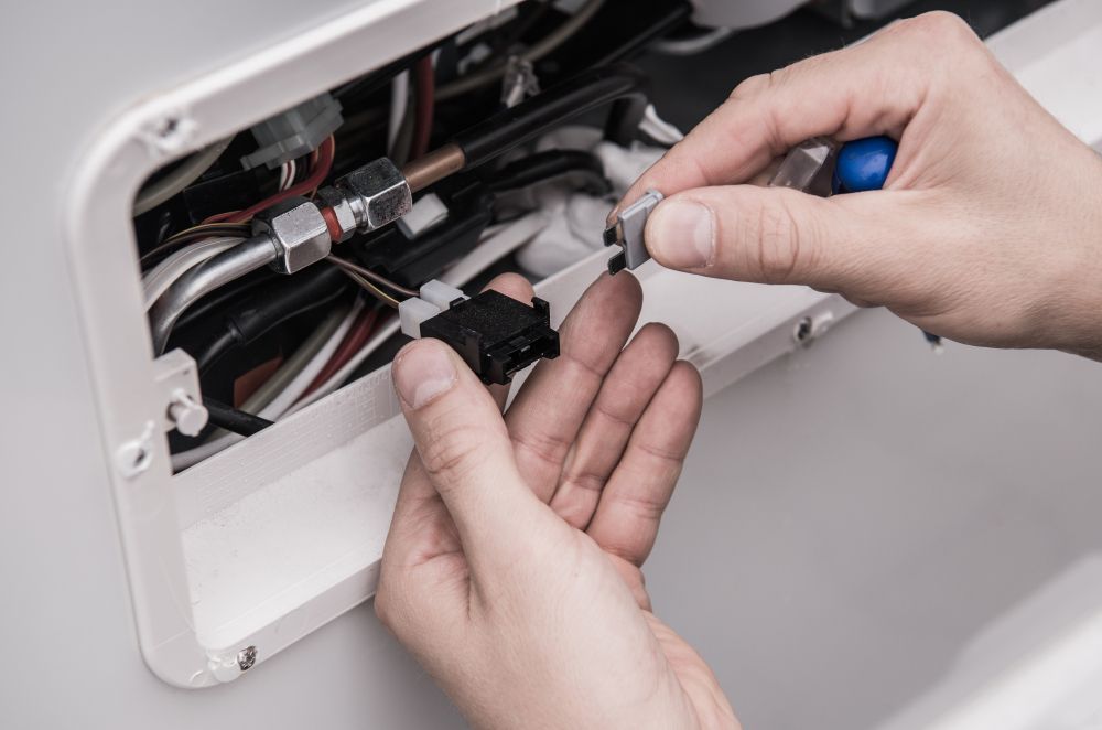 Close-up of Hands Connecting Electrical Wires — Eurocoast Appliance Service In Gosford, NSW