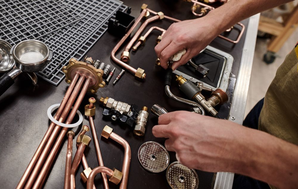 Technician Assembling Copper Pipes and Parts — Eurocoast Appliance Service In Wyong, NSW