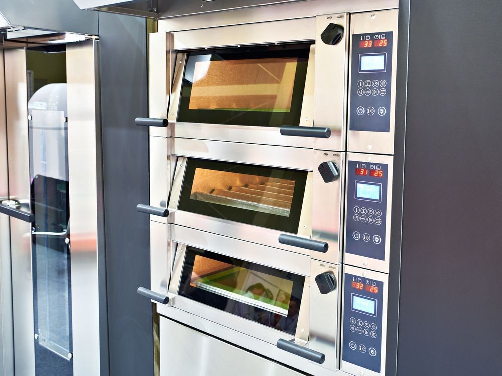 A Stack of Three Industrial Stainless Steel Bakery Ovens — Eurocoast Appliance Service In Morisset, NSW