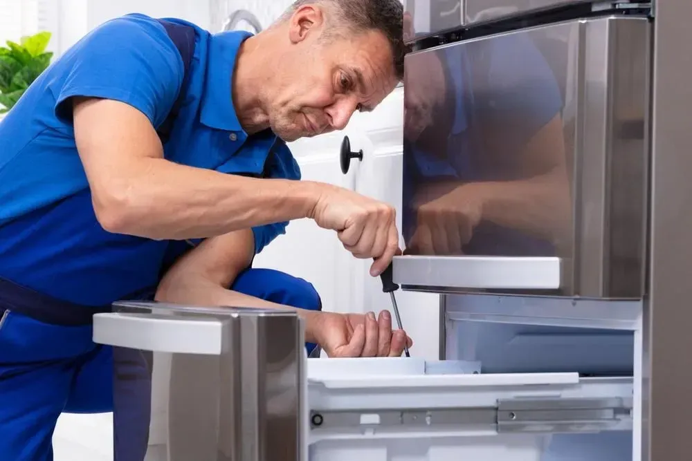 Professional Technician Uses a Screwdriver to Repair the Refrigerator — Eurocoast Appliance Service In Morisset, NSW