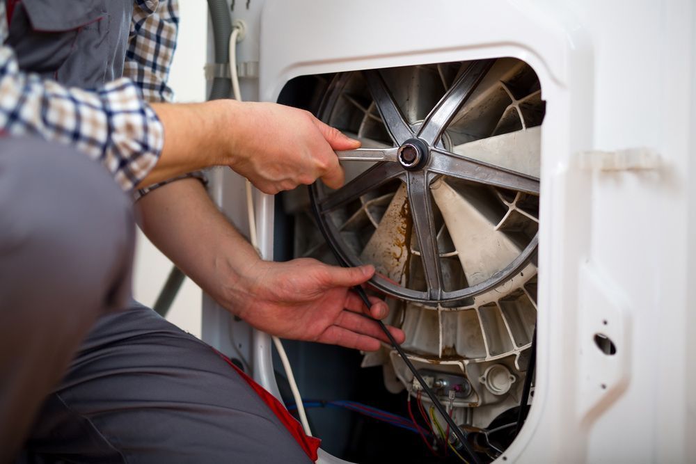 A Service Technician Using a Wrench — Eurocoast Appliance Service In Tuggerah, NSW