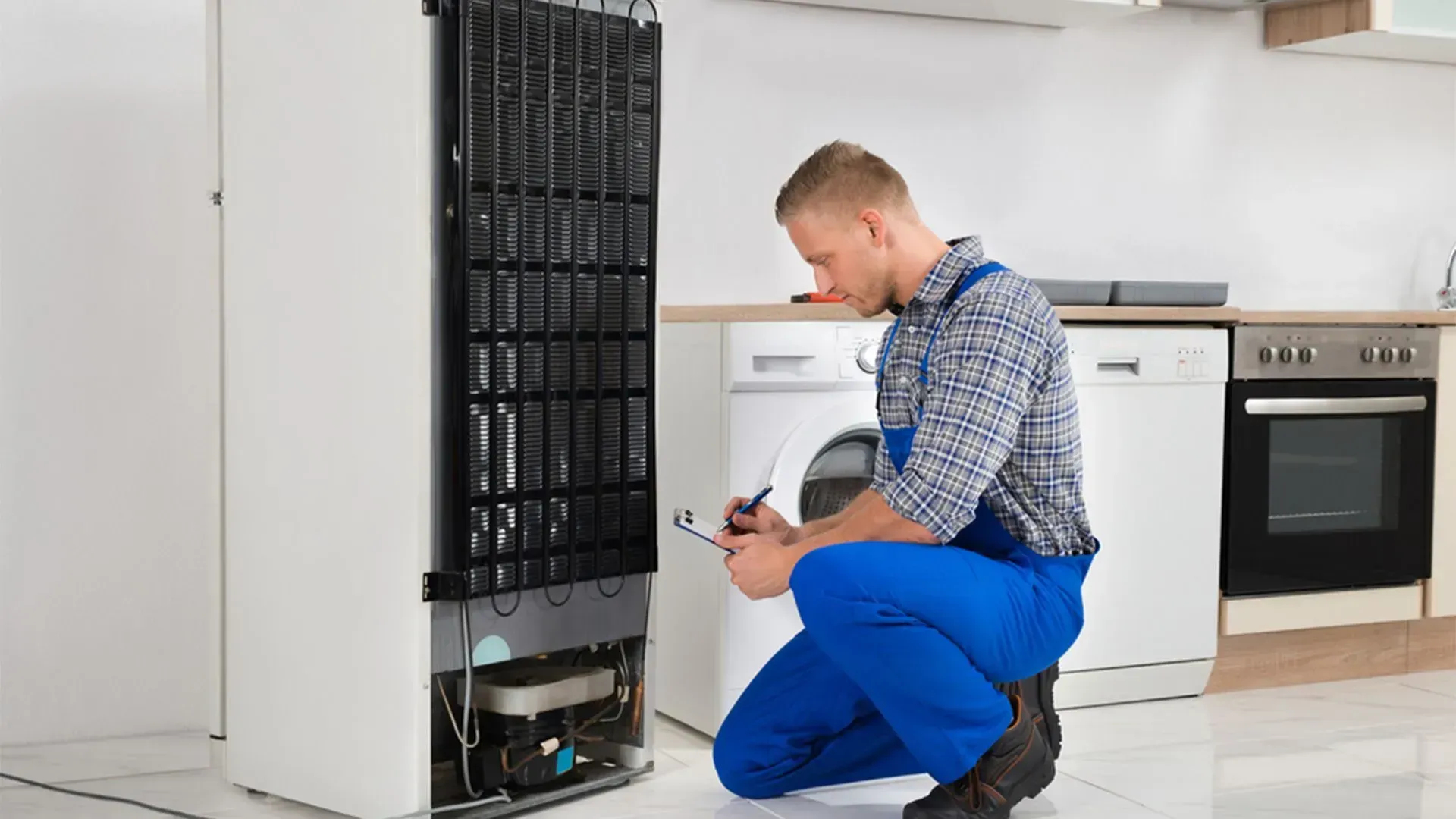 Technician Inspect the Back of a Refrigerator — Eurocoast Appliance Service In Wyong, NSW