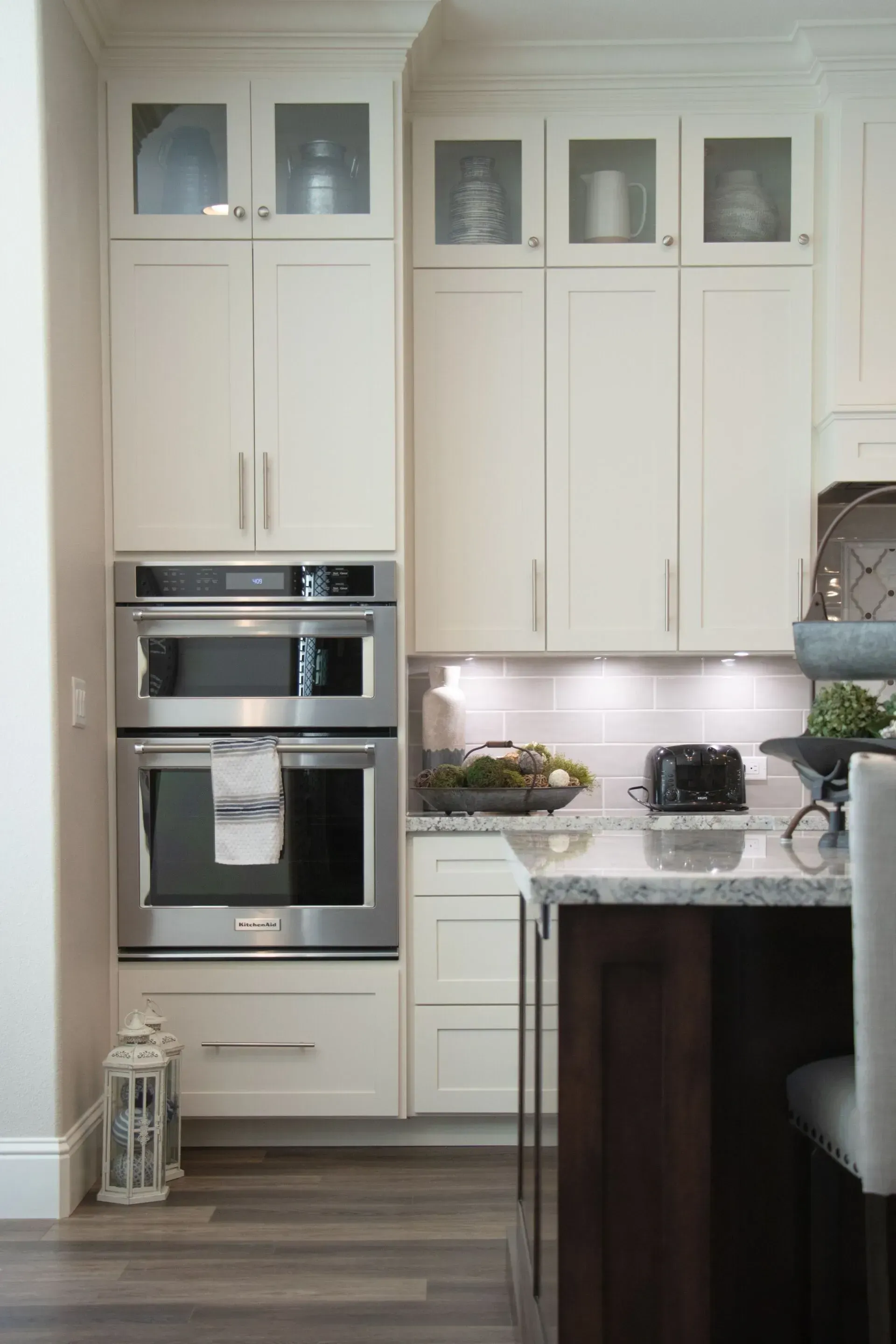 Two People Installing a Built-in Oven and Microwave Unit — Eurocoast Appliance Service In Tuggerah, NSW