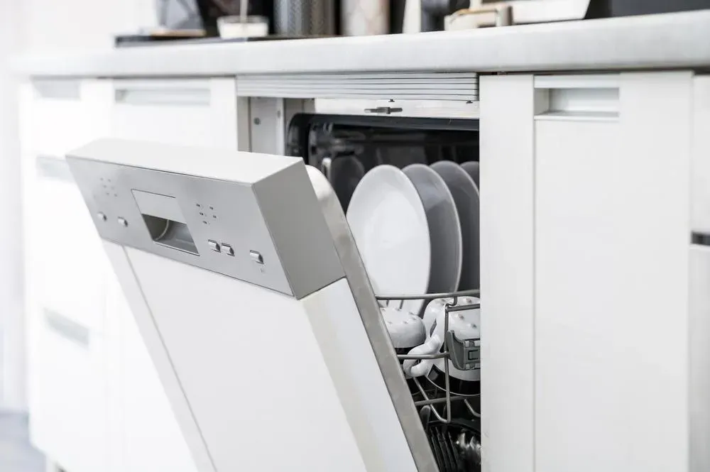 Partially Open, Modern White Dishwasher — Eurocoast Appliance Service In Tuggerah, NSW