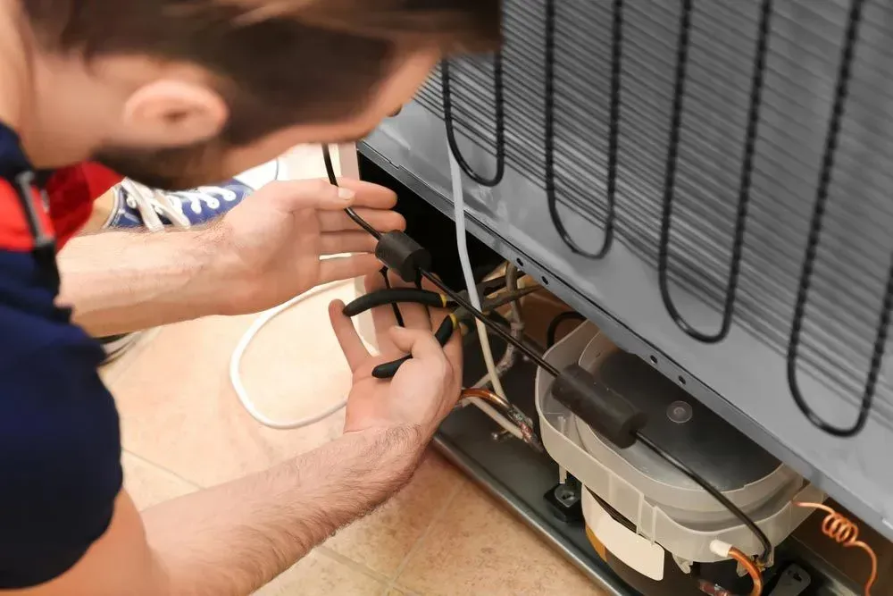 Repair Technician is Working on the Back Components — Eurocoast Appliance Service In Tuggerah, NSW
