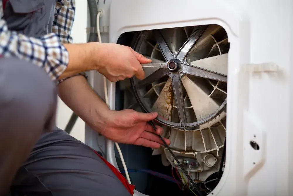 Person in a Plaid Shirt Repairs the Internal Motor Mechanism — Eurocoast Appliance Service In Tuggerah, NSW