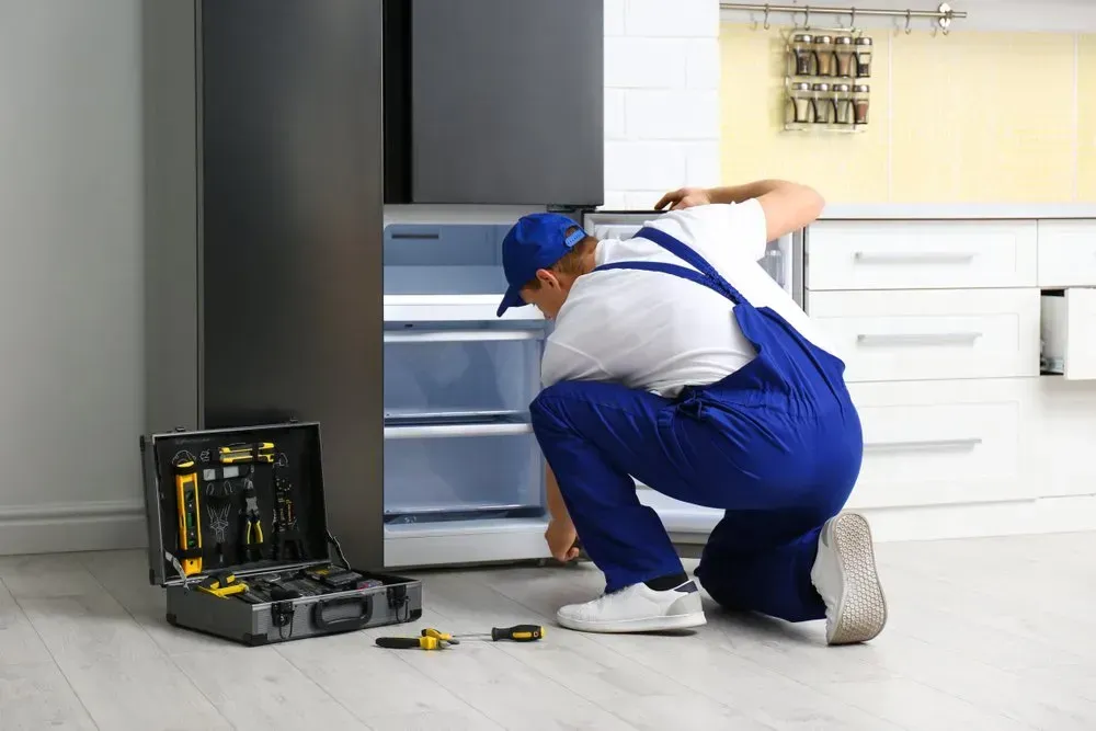 Technician in Blue Coveralls — Eurocoast Appliance Service In Tuggerah, NSW