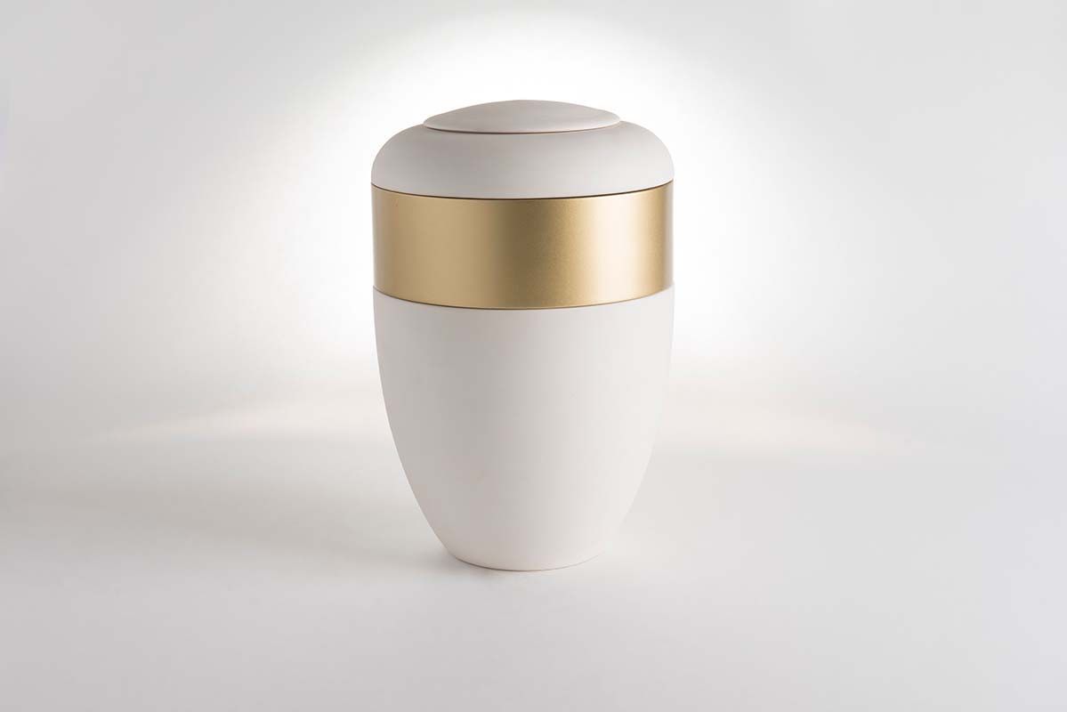 White and gold cremation urn.