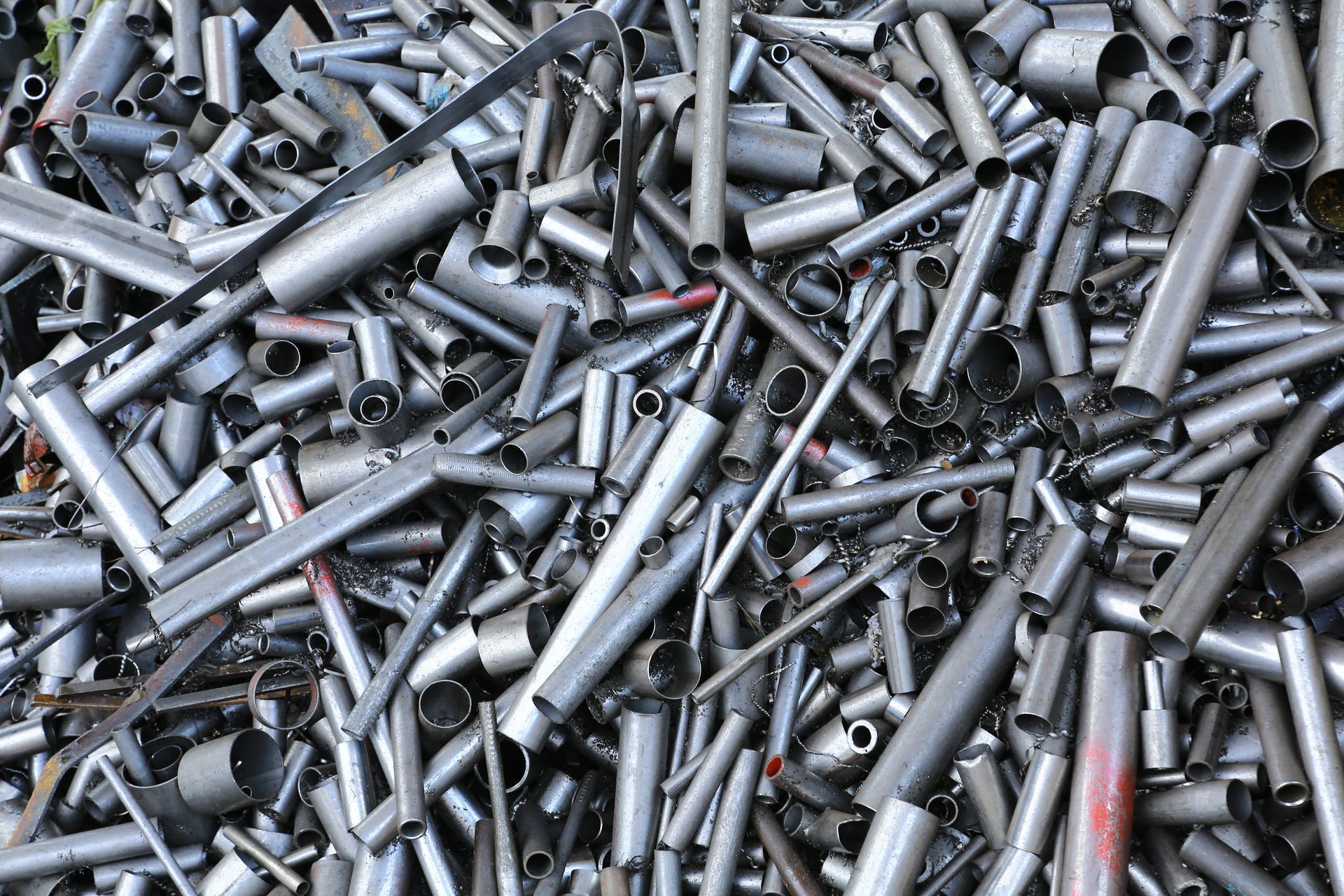 Pile of silver metal bolts and screws scattered in a heap.