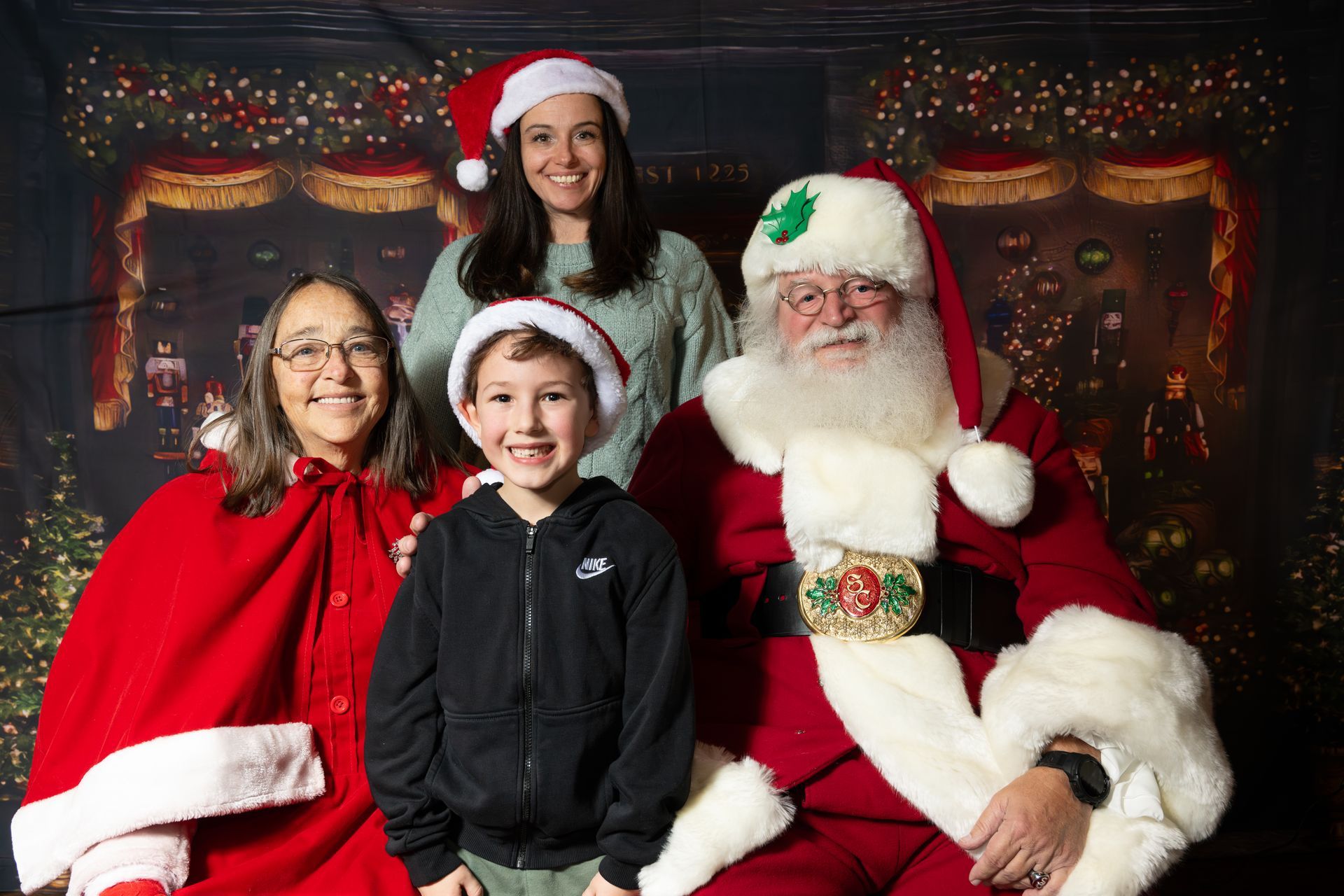 Family poses with Santa Claus in a festive setting.