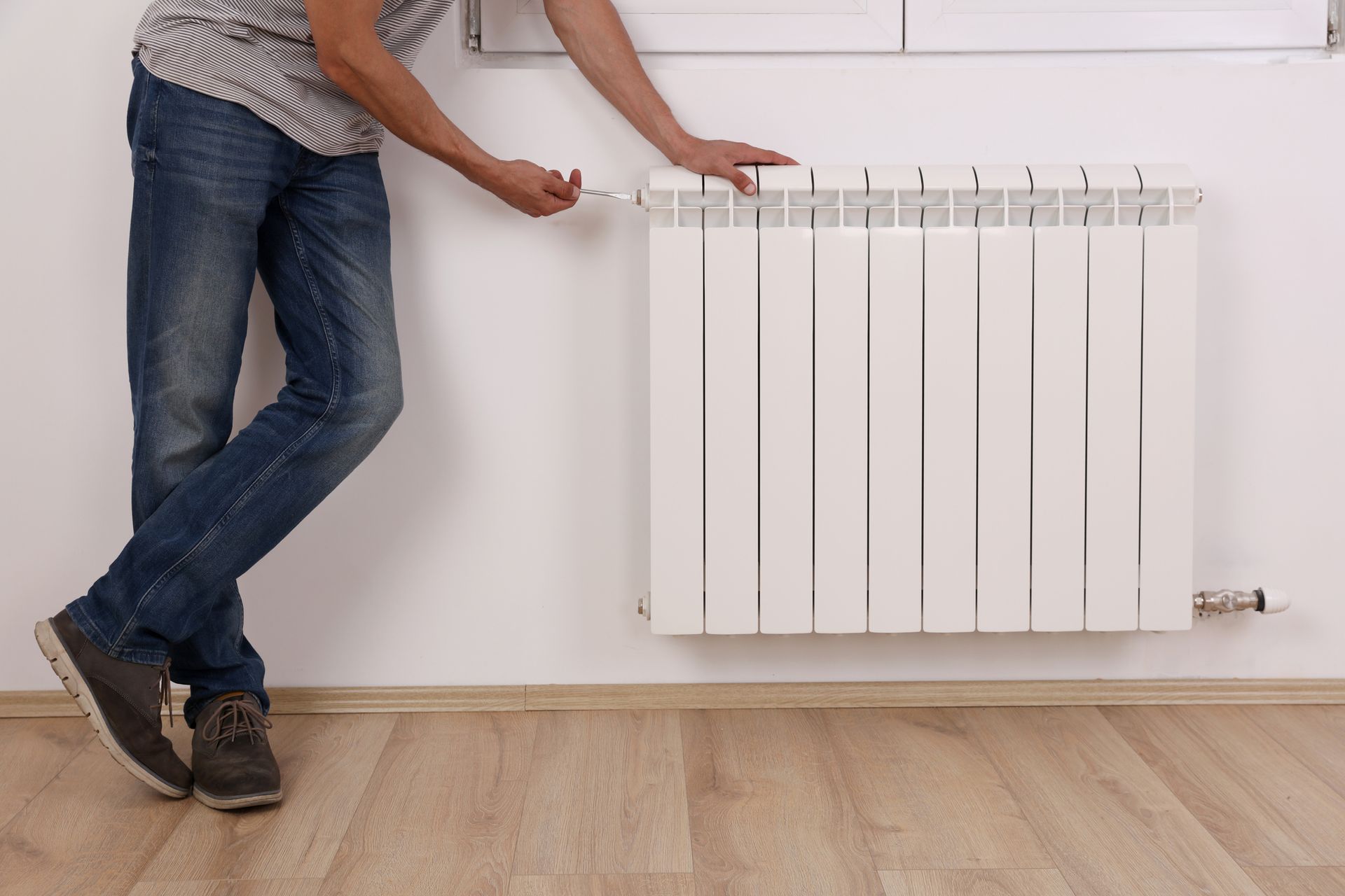 A Man Is Standing Next To A Heater - Wilmington, DE - Woodrow Services