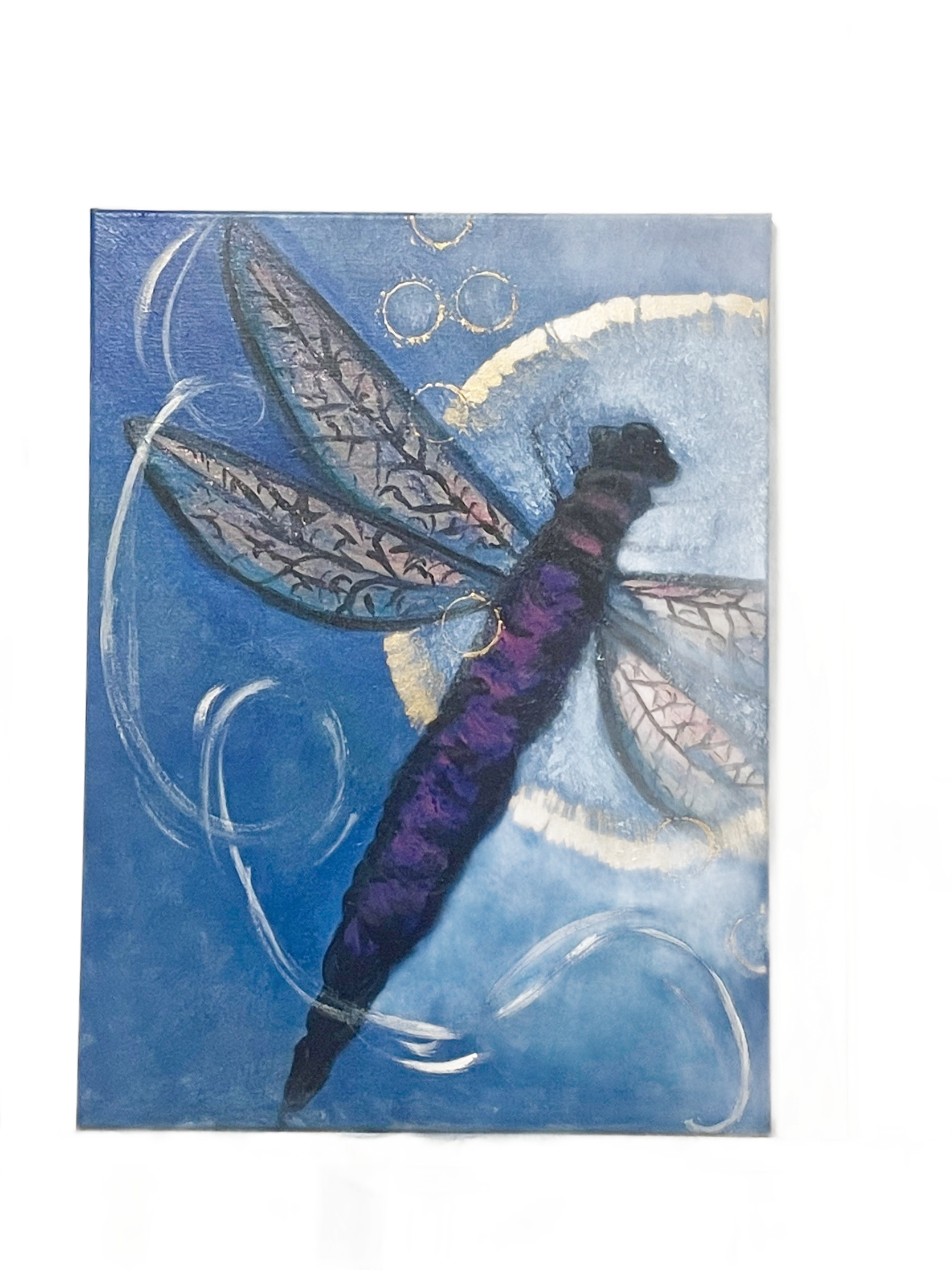 Purple dragonfly painting with translucent wings over a blue, cloudy background