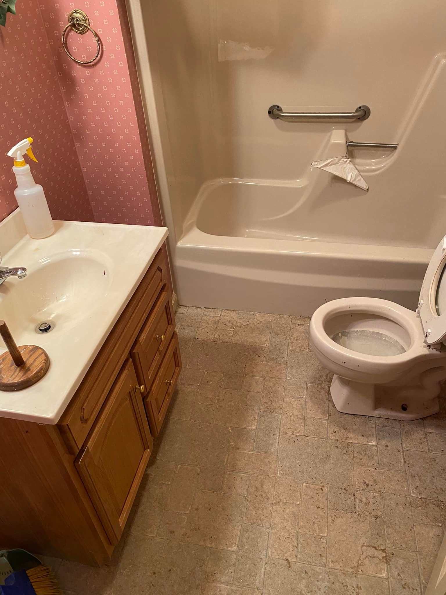 A bathroom with a toilet , sink , bathtub and shower.
