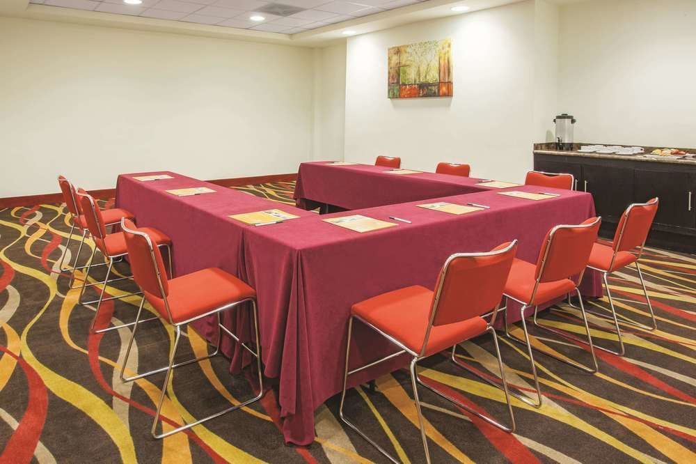 Una sala de conferencias con mesas y sillas en forma de U.