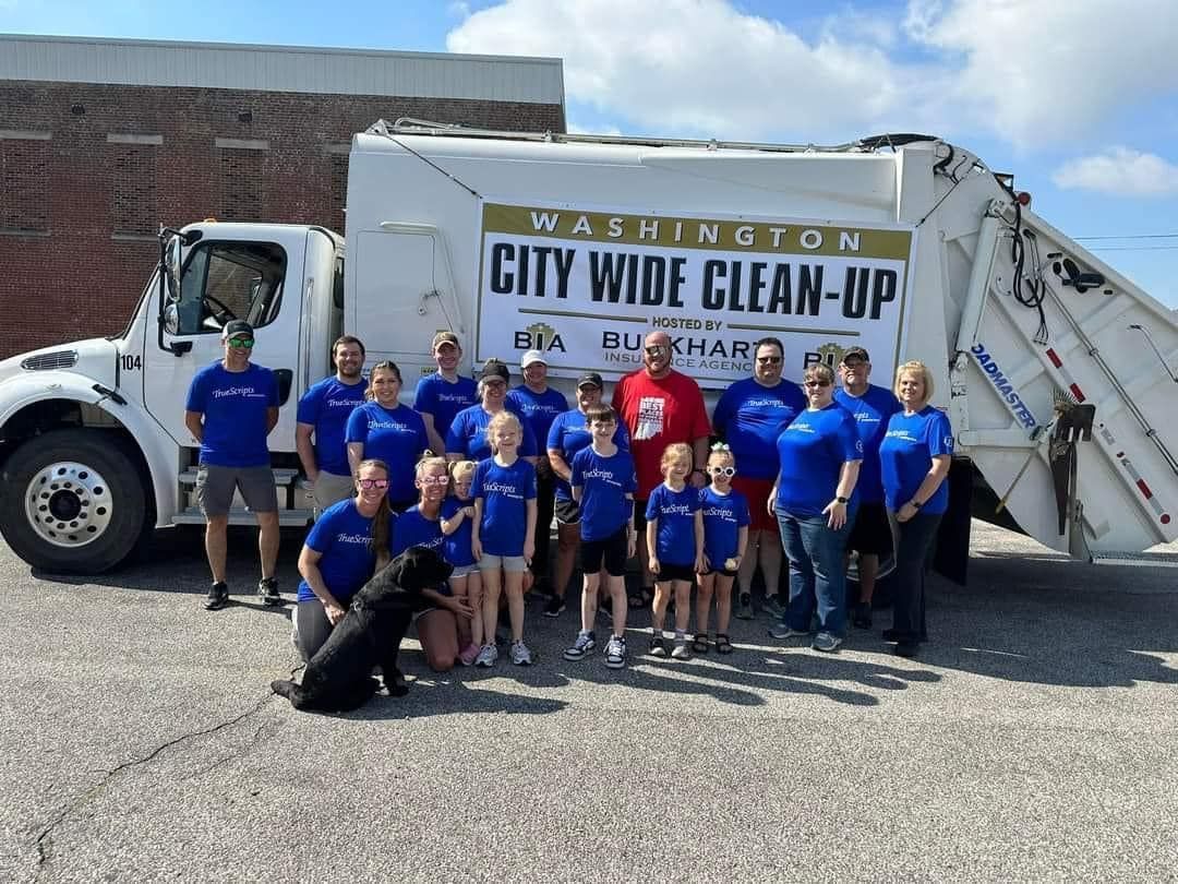 Group of TrueScripts employees posing together smiling at a volunteer event