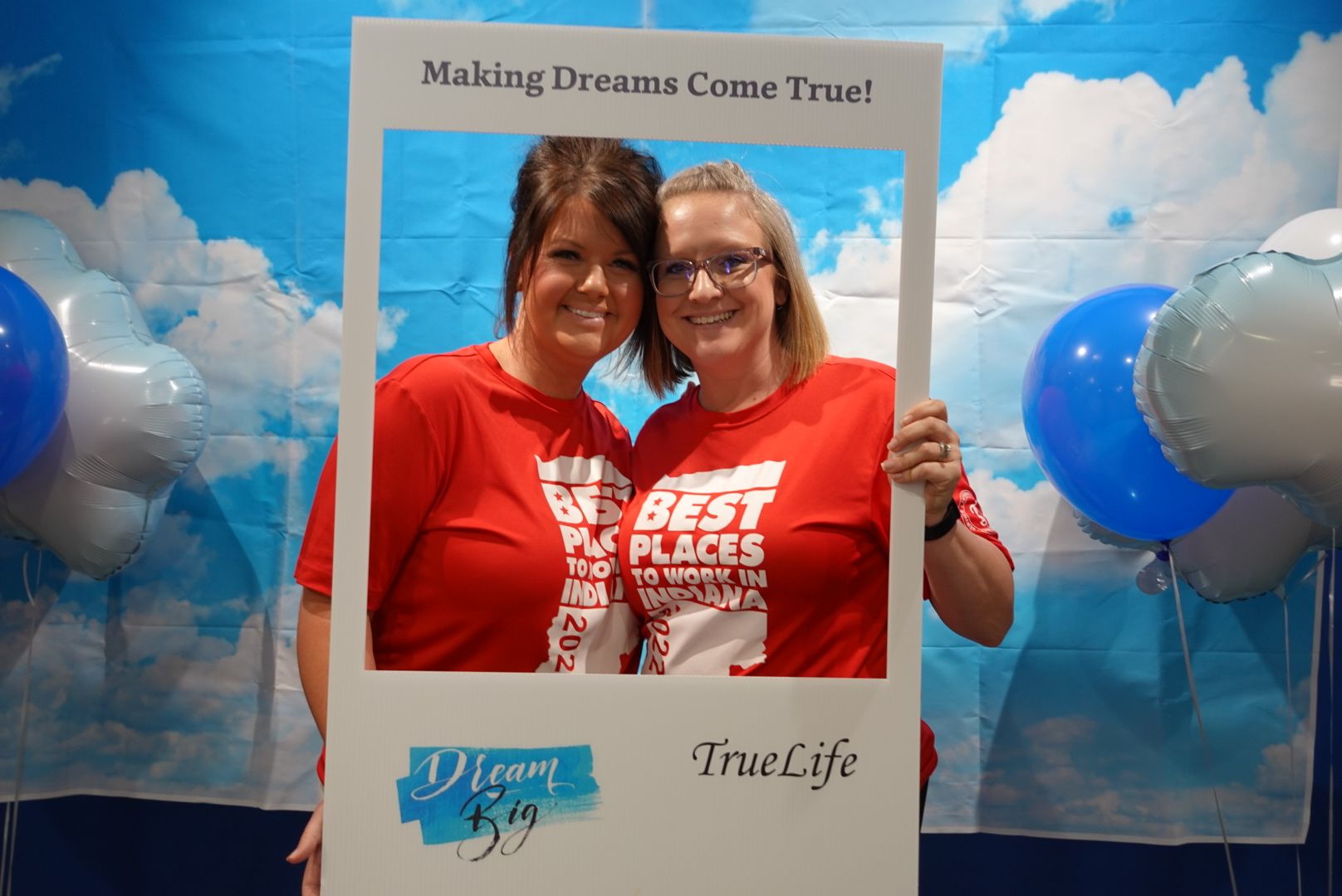 Two TrueScripts employees posing together smiling at a volunteer event