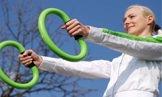 Person mid-swing outdoors with Smovey rings