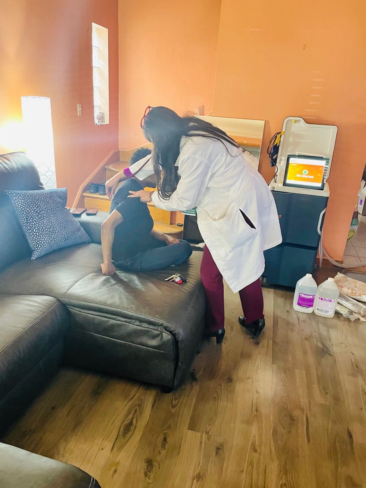 a Vitality Dialysis medical professional helping a patient with an in-home hemodialysis treatment