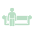 A man is sitting on a couch in a living room.