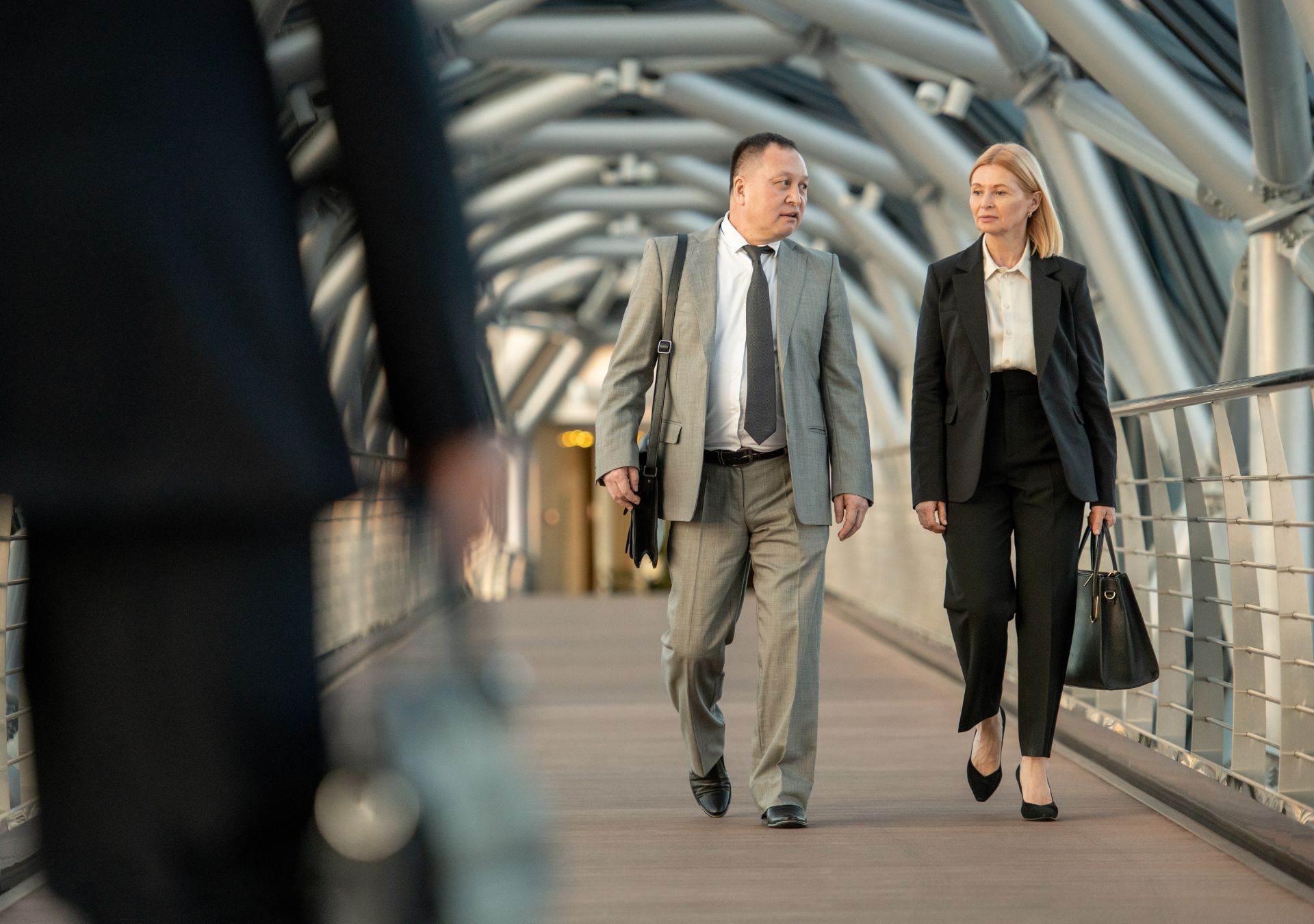 Business professionals walking through a Lower Manhattan office building walkway, representing NYC security guard workers compensation coverage