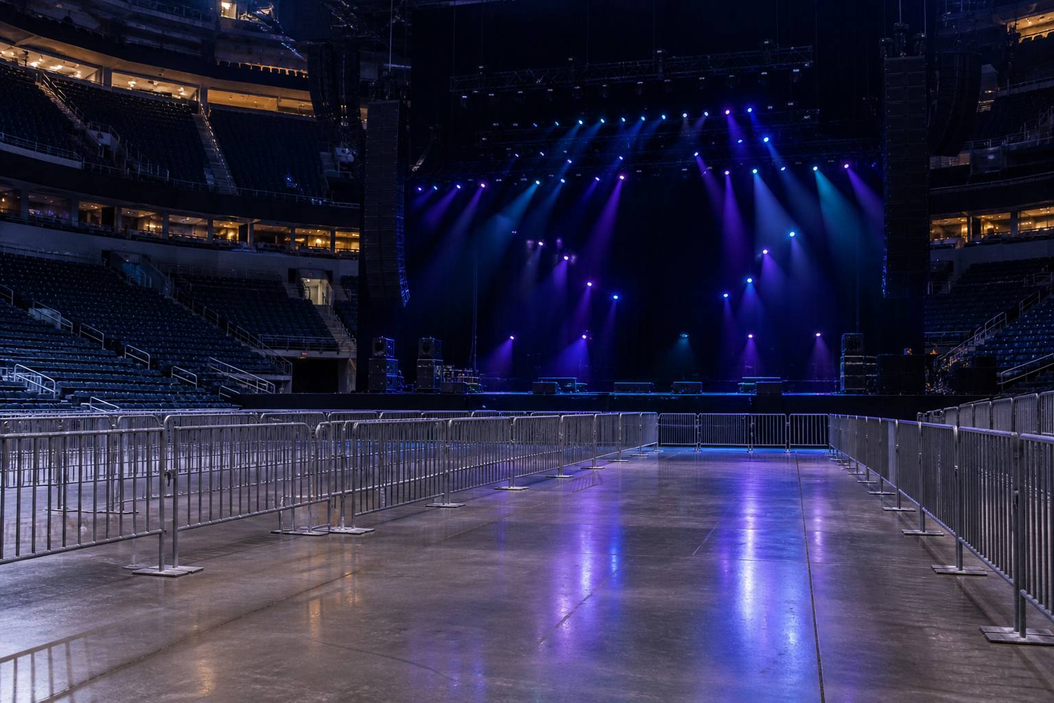 Empty New York City concert arena with stage lighting and floor barricades, illustrating NYC event s