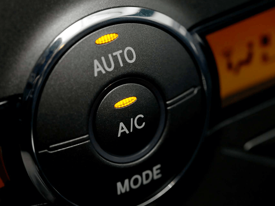 A close up of an auto and a/c mode button