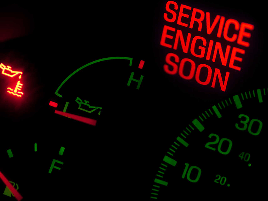 A service engine soon sign is lit up on a dashboard