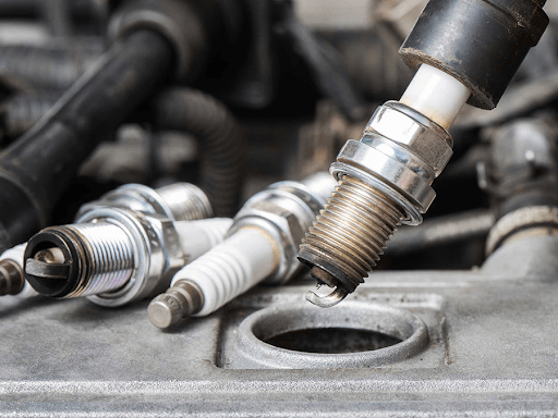 A close up of a spark plug in a car engine.