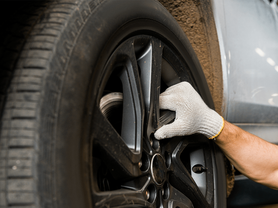 A person is changing a tire on a car.