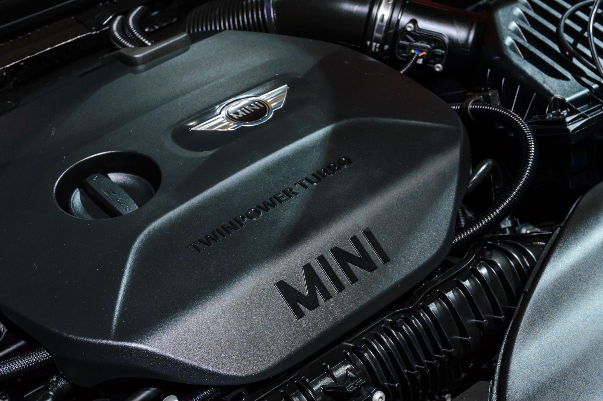 A close up of the engine of a mini cooper.