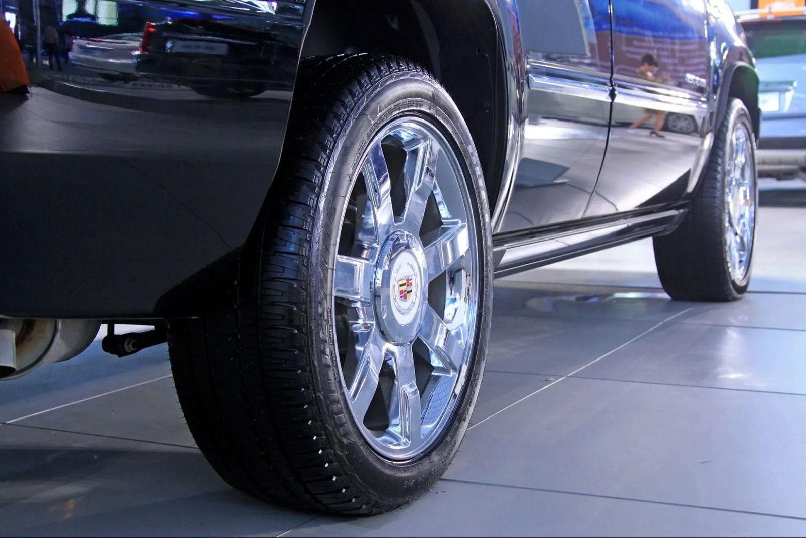 A close up of a car wheel on a tiled floor