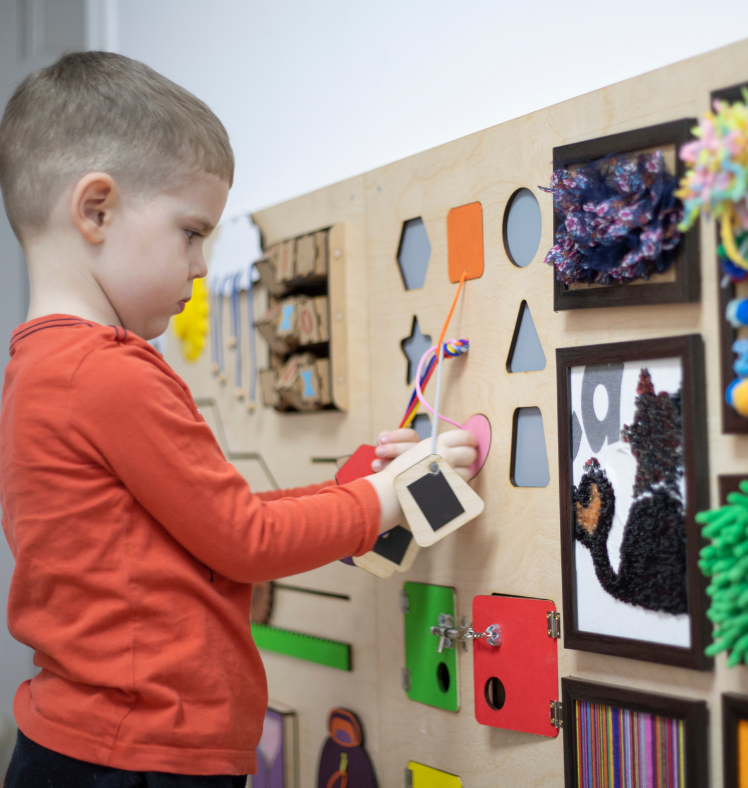 A picture of a little boy playing with toys.