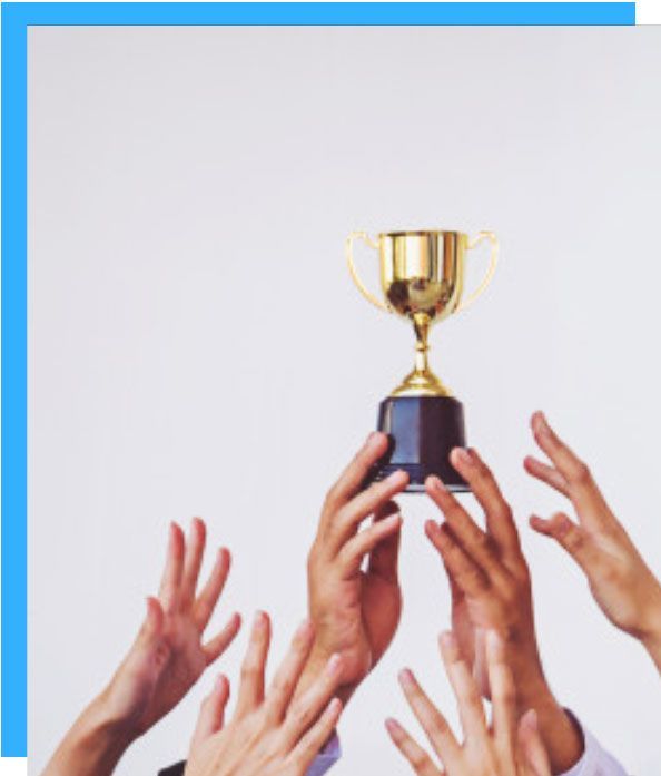 Hands reaching up to hold a golden trophy against a white background.