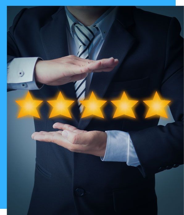 Man in suit holding up five gold stars.